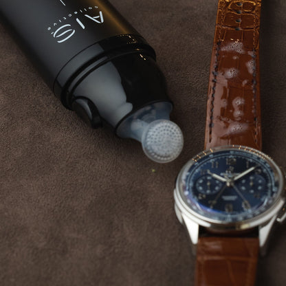 Gently cleaning and restoring the luxury leather strap of a Breitling watch using the integrated brush head of the ChronoLeatherPen.