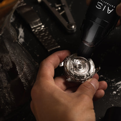 Using the soft bristles of the AIS Collective ChronoPen to safely clean and maintain a luxury stainless steel watch.