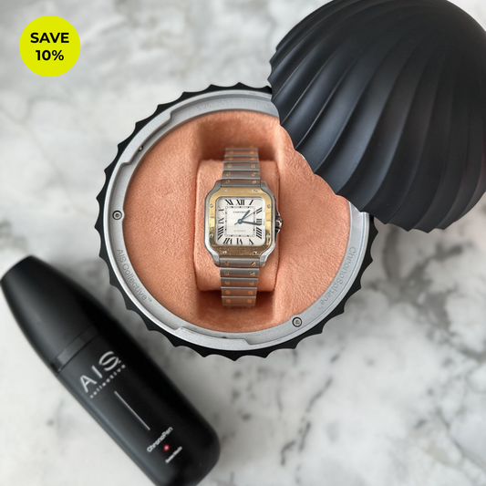AIS Collective ChronoPen cleaning spray next to a luxury Cartier watch displayed inside a Salmon pink ChronoSphere watch stand.